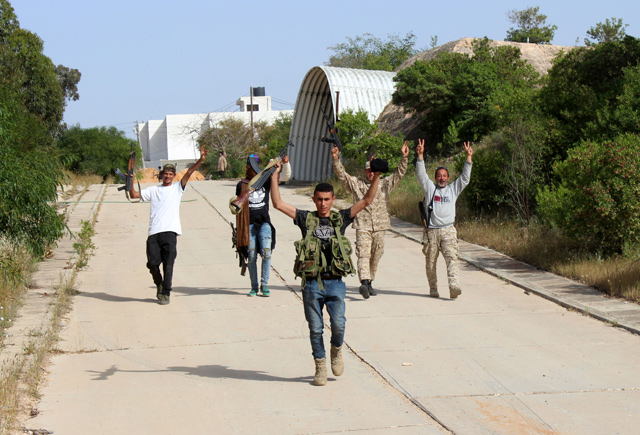   Members of the Libyan internationally recognised government forces gesture victory signs at Khallat Farjan area in Tripoli, Libya, on Saturday (Reuters photo)