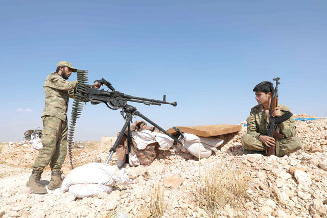 Syrian rebel-fighter from the National Liberation Front mans a position at the frontline facing regime areas in the southern countryside of Aleppo on Sunday (AFP photo)