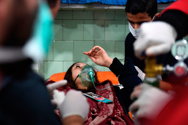 A Syrian woman receives treatment at a hospital in the regime controlled Aleppo on Saturday  (AFP photo)