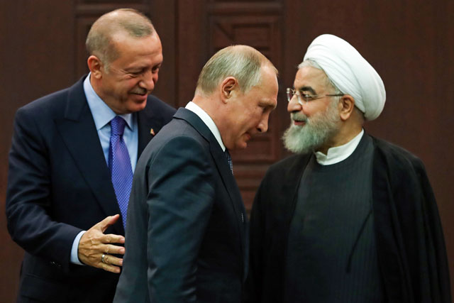   Turkish President Recep Tayyip Erdogan (left), Russian President Vladimir Putin (centre) and Iranian President Hassan Rouhani (right) leave after a press conference following a trilateral meeting on Syria, in Ankara, on Monday (AFP photo)