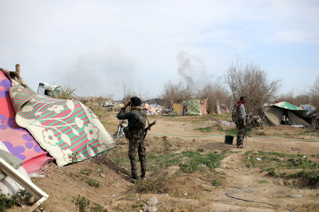 Fighters of Syrian Democratic Forces are seen in the village of Baghouz, Deir Ezzor province, Syria, on Sunday  (Reuters photo)