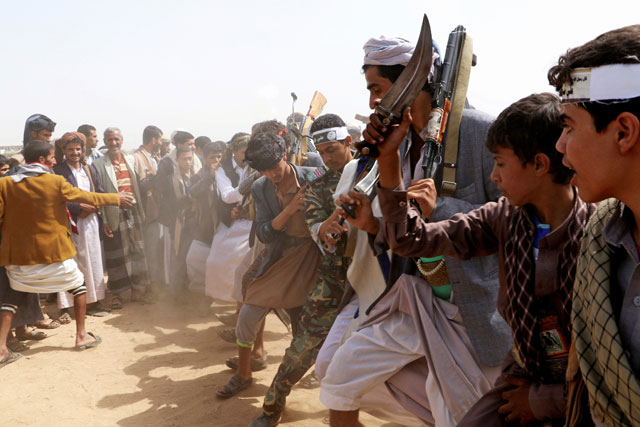 Followers of the Shiite Houthi movement perform the traditional Baraa dance as they take part in a ceremony marking Al Ghadeer day in Saada, Yemen, on Wednesday (Reuters photo)