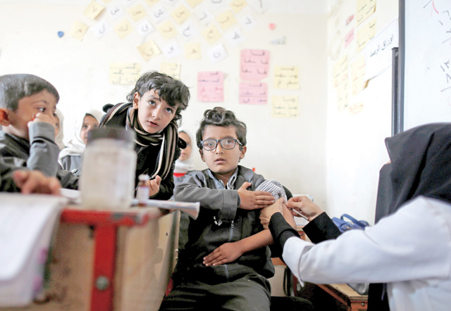 A boy receives a vaccination for measles and rubella at his school as a six-day immunisation campaign kicks off in Sanaa, Yemen, on Saturday (Reuters photo)