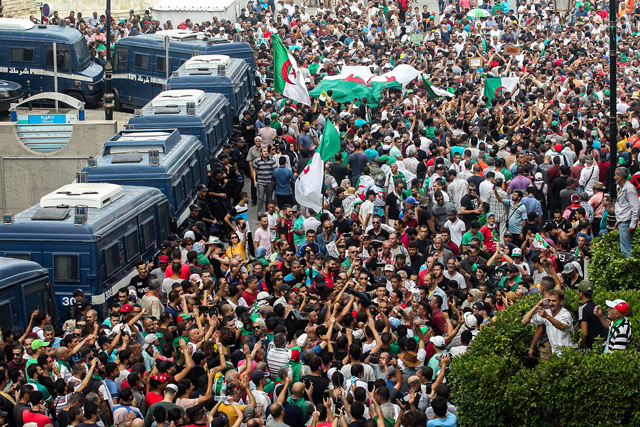 Algerian protesters take part in a demonstration against the country's army chief in Algeria's capital Algiers on Friday, as the police toughens its line ahead of December elections  (AFP photo)