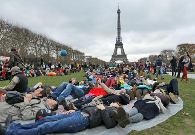 Activists stage a ‘die-in’ during a demonstration near the Eiffel Tower in Paris, Saturday, during the COP21, the United Nations Climate Change Conference (AP photo)