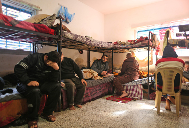 Palestinians, who are unable to pay off their debts, sit in a cell in a Hamas jail in Gaza City on February 20 (AFP photo)