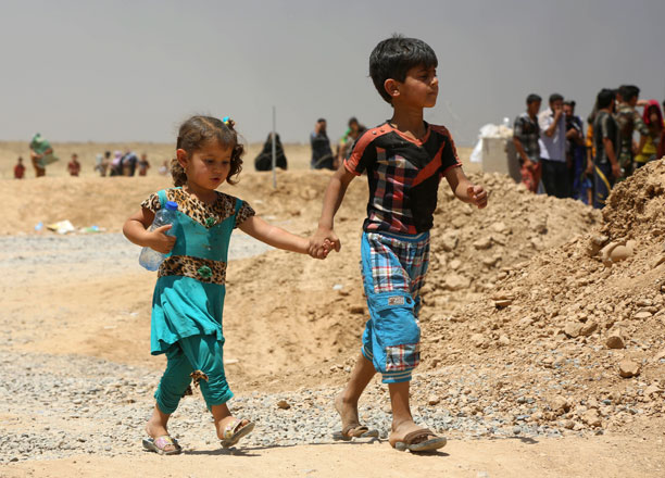 In this Friday picture, displaced civilians, who fled their Daesh-held towns and villages south of Mosul, arrive to a camp for the displaced outside Erbil, 350km north of Baghdad (AP photo)