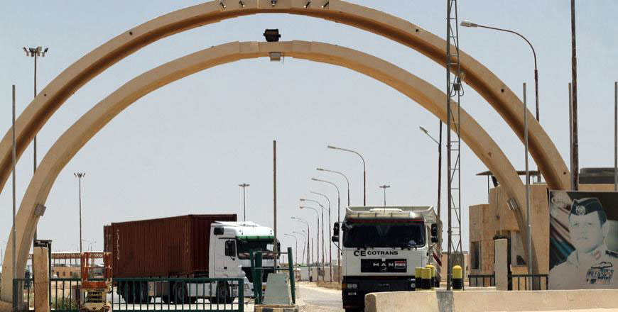 Trucks are seen at the Karameh-Turaibil border crossing between Jordan and Iraq, which have not been allowed to enter since the border’s reopening, unloading their cargo at the border instead to be reloaded in Iraqi trucks (JT file photo)