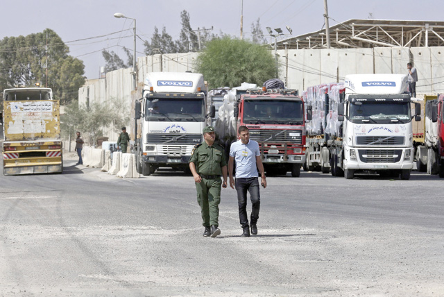Members of Palestinian security forces check fuel tankers as they arrive at Kerem Shalom crossing in Rafah in the southern Gaza Strip on Wednesday (AFP photo)
