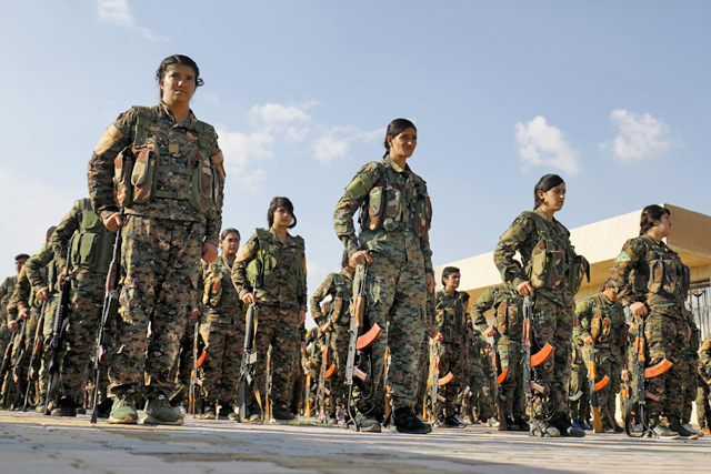 Fighters from the Syrian Democratic Forces participate in a military parade during the funeral of a fellow fighter, killed during a military mission, in the Kurdish-controlled city of Qamishly in northeastern Syria, on Sunday  (AFP photo)
