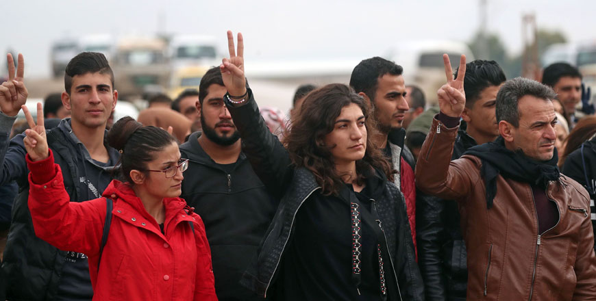 Syrian Kurds take part in a demonstration in the northeastern Syrian Kurdish-majority city of Qamishli on Friday, against threats from Turkey to carry out a fresh offensive following the US decision to withdraw their troops (AFP photo)