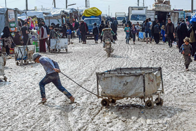   In this file photo taken on March 28 a boy pulls a cart in Al Hol camp which houses relatives of Daesh group members, in Al Hasakeh governorate in northeastern Syria (AFP photo)