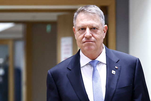 Romania's President Klaus Iohannis arrives to attend a European Council summit at the EU headquarters in Brussels on March 21, 2024 (AFP photo)