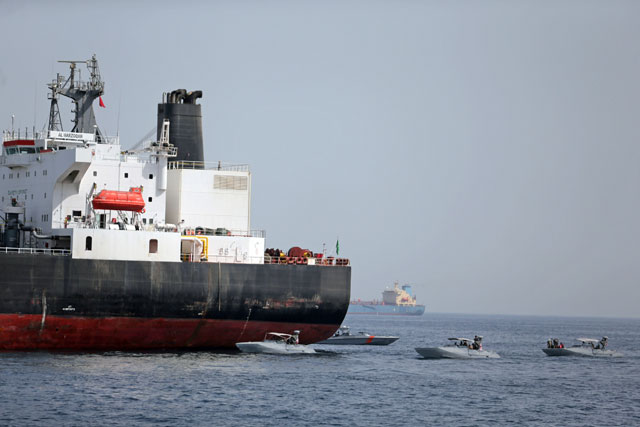UAE navy boats are seen next to Al Marzoqah, Saudi Arabian tanker, off the Port of Fujairah, UAE, on Monday (Reuters photo)