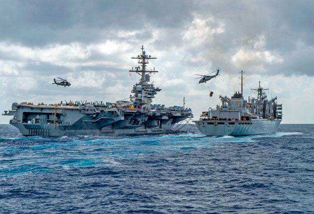   This handout photo released by the US navy on May 8 shows the Nimitz-class aircraft carrier USS Abraham Lincoln (CVN 72) while conducting a replenishment-at-sea with the fast combat support ship USNS Arctic (T-AOE 9), while MH-60S Sea Hawk helicopters assigned to the 'Nightdippers' of Helicopter Maritime Strike Squadron (HSM) 5, transfer stores between the ships (AFP photo)