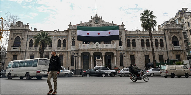 People walk in front of the historic Hejaz train station in Damascus, Syria on Sunday (AFP photo)