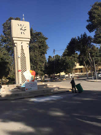 A sanitation worker cleans the area near the clock tower at the University of Jordan after classes were suspended on Thursday (Photo courtesy of Thabahtoona)