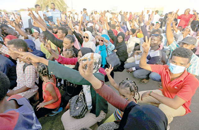 Sudanese demonstrators chant slogans as they attend a mass anti-government protest outside Defence Ministry in Khartoum, Sudan, on Monday (Reuters photo)