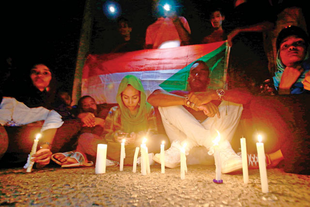 Sudanese protesters take part in a vigil in the capital Khartoum to mourn dozens of demonstrators killed last month in a brutal raid on a Khartoum sit-in on Saturday (AFP photo)
