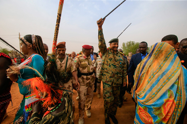   General Abdel Fattah Al Burhan, the head of Sudan's ruling military council, greets his supporters in Khartoum's twin city of Omdurman on Saturday (AFP photo)