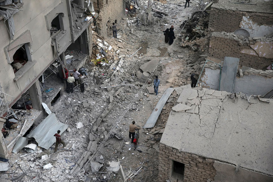 Residents inspect damage from what activists said was an air strike by forces loyal to Syria’s President Bashar Assad on the main field hospital in the town of Douma, Eastern Ghouta in Damascus, on Thursday (Reuters photo)
