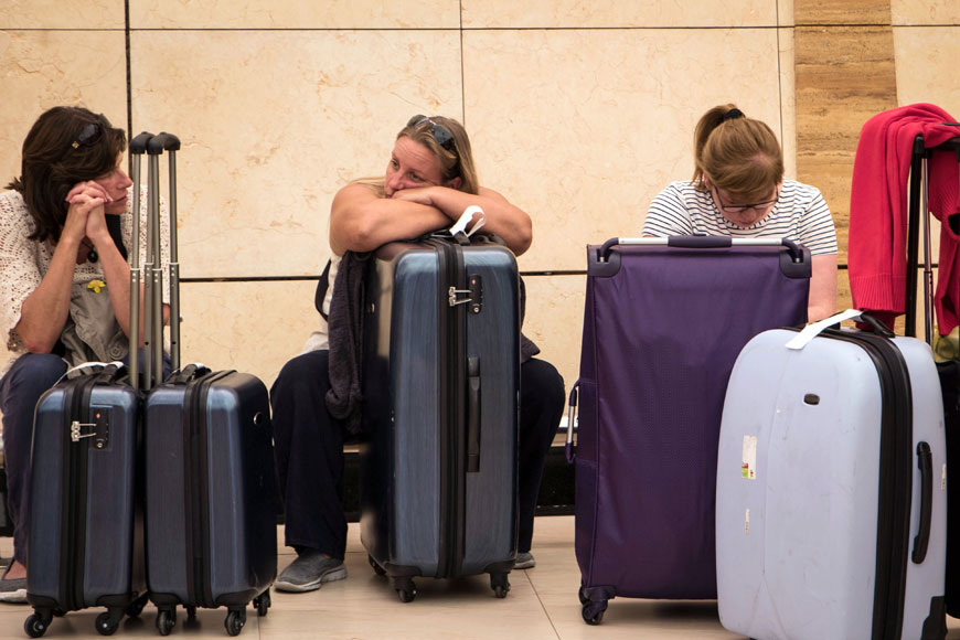 Tourists wait by their luggage at the departure lounge in Sharm El Sheikh Airport, south Sinai, Egypt, on Friday (AP photo)