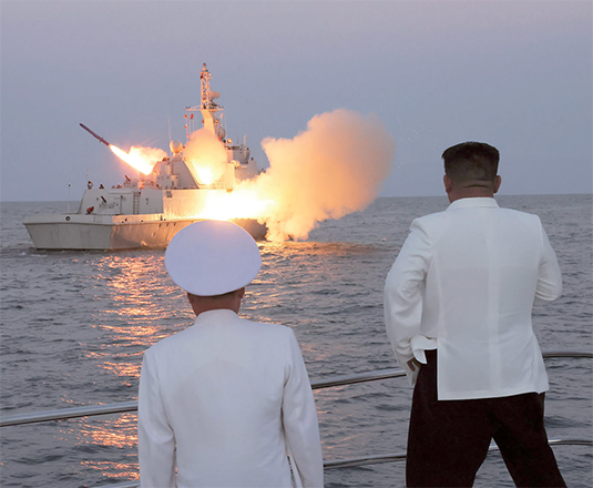 This undated photo released from North Korea's official Korean Central News Agency (KCNA) on Monday shows North Korea's leader Kim Jong-un (right) watching a strategic cruise missile being launched from a guard ship marine of the 2nd Surface Ship Squadron of the East Sea fleet, also known as the Sea of Japan (AFP photo)