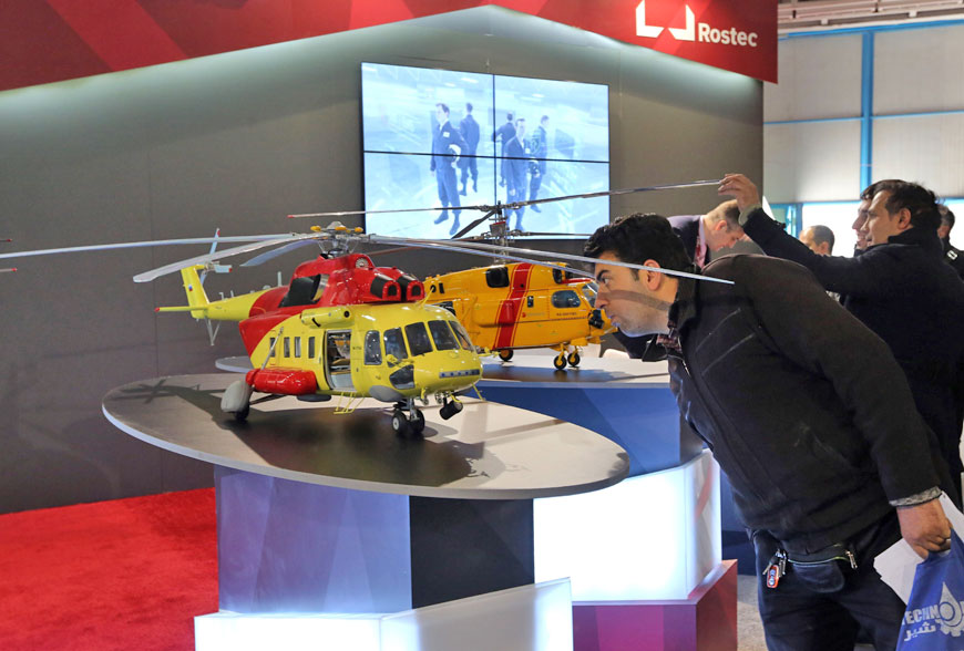 An Iranian man looks at model of a helicopter at the stand of the Russian company Rostec during the Russia National Industrial Exhibition in Tehran, on Tuesday  (AFP photo)