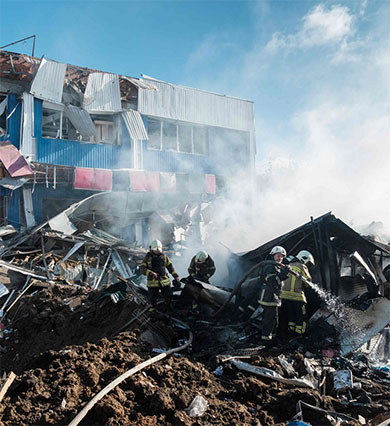 Firefighters extinguish a fire at a local market damaged following a shelling in the town of Bakhmut, eastern Ukraine, on Thursday, amid the Russian invasion of Ukraine (AFP photo)