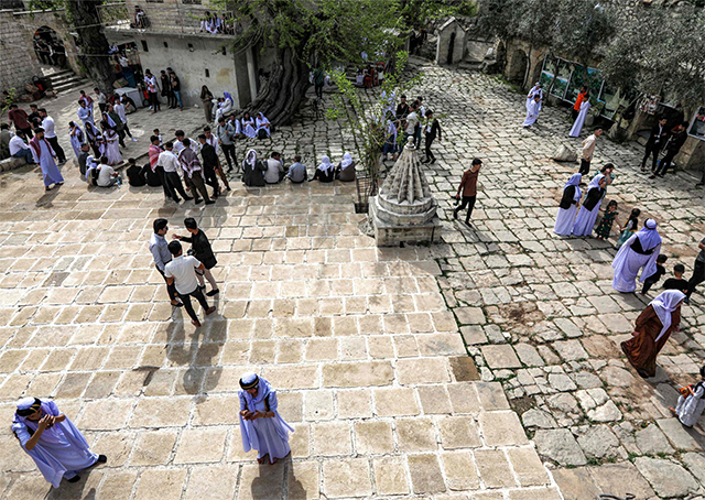 Iraqi Yazidis gather to attend a ceremony marking the Yazidi New Year outside the Temple of Lalish in a valley near the Kurdish city of Dohuk, on Tuesday (AFP photo)