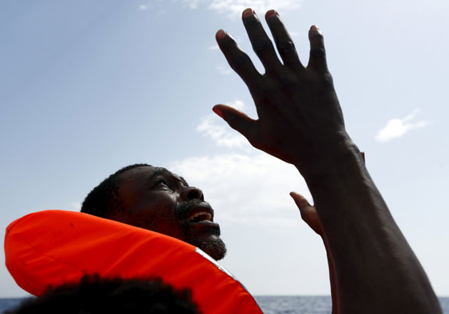 A migrant, who has just been rescued, prays on a Migrant Offshore Aid Station (MOAS) RHIB (Rigid-hulled inflatable boat) whilst being taken to the MOAS ship MV Phoenix, some 32 kilometres off the coast of Libya, Monday. Some 118 migrants were rescued from a rubber dinghy off Libya on Monday morning. The Phoenix, manned by personnel from international non-governmental organisations Medecins san Frontieres and MOAS, is the first privately funded vessel to operate in the Mediterranean (Reuters photo)