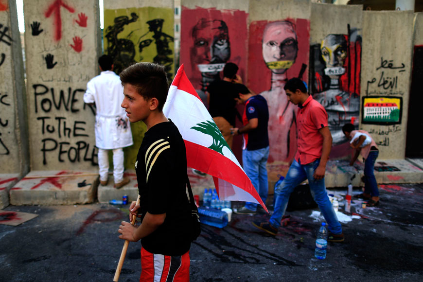 Lebanese activists protest in front a concrete wall installed by authorities, and quickly covered with graffiti, near the main Lebanese government building a day after violent anti-government protests, in downtown Beirut, Lebanon, Monday (AP photo)