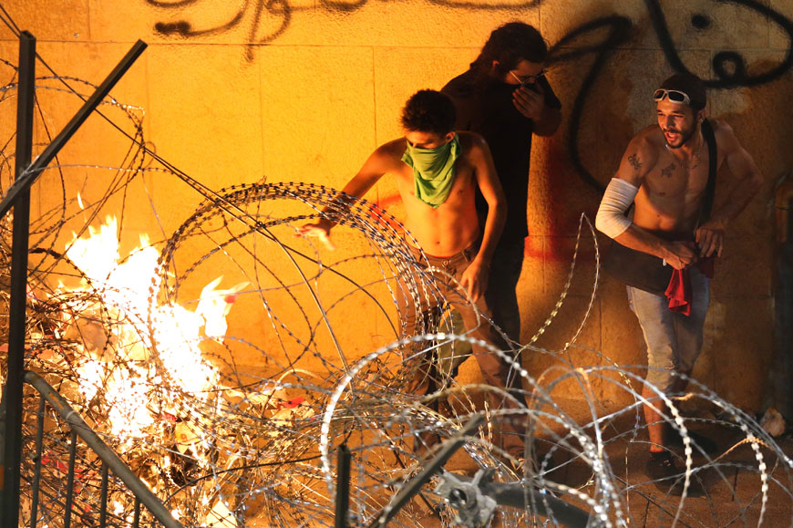 Lebanese anti-government protesters burn the barbed wires that block the road to the government building, during a demonstration against the ongoing trash crisis and government corruption, in downtown Beirut, Lebanon, Saturday (AP photo)