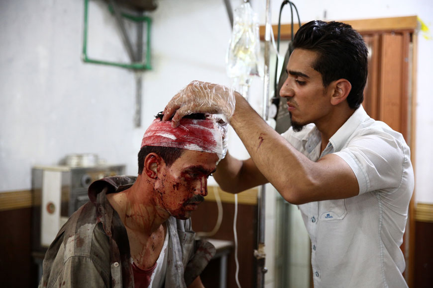 A Syrian man receives treatment at a makeshift hospital following reported air strikes by government forces in the rebel-held area of Douma, east of the capital Damascus, on Saturday (AFP photo)