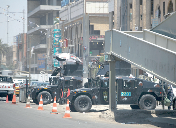 Iraqi security forces secure Palestine Street the day after some 30 people attacked two restaurants, including the American KFC, in Baghdad on Tuesday (AFP photo)