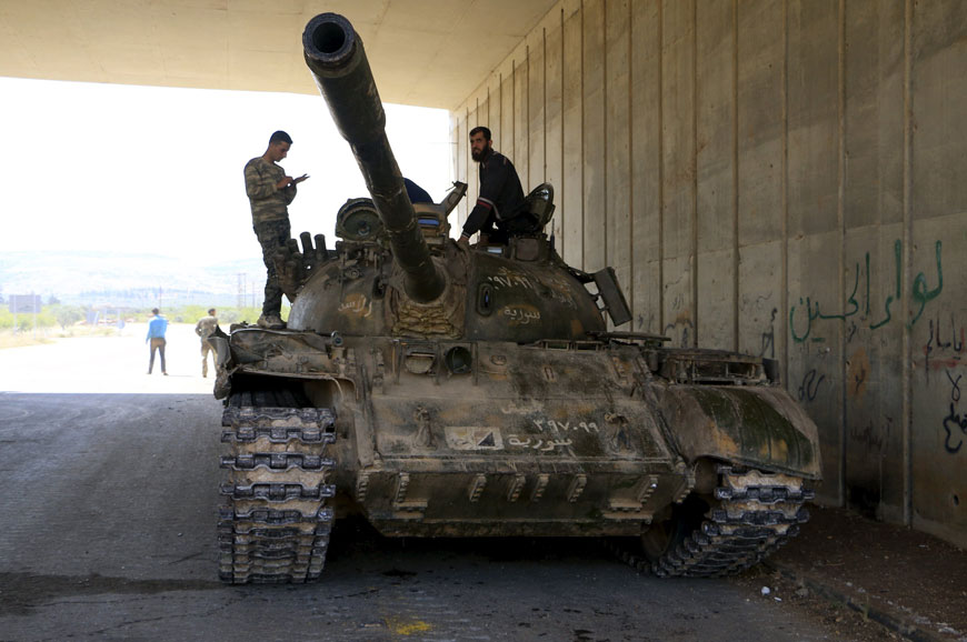 Fighters from a coalition of rebel groups called ‘Jaish Al Fateh’, also known as ‘Army of Fatah’ (Conquest Army), stand on a tank in an underpass near Psoncol town after saying they had taken control of it, on a highway that heads to Latakia, in the Idlib countryside, Syria, on Saturday (Reuters photo)