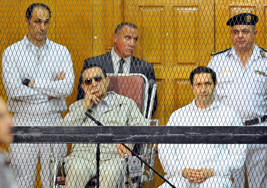 In this September 14, 2013 file photo, former Egyptian president Hosni Mubarak (seated centre left) and his two sons, Gamal Mubarak (left) and Alaa Mubarak attend a hearing in a courtroom in Cairo, Egypt (AP photo)