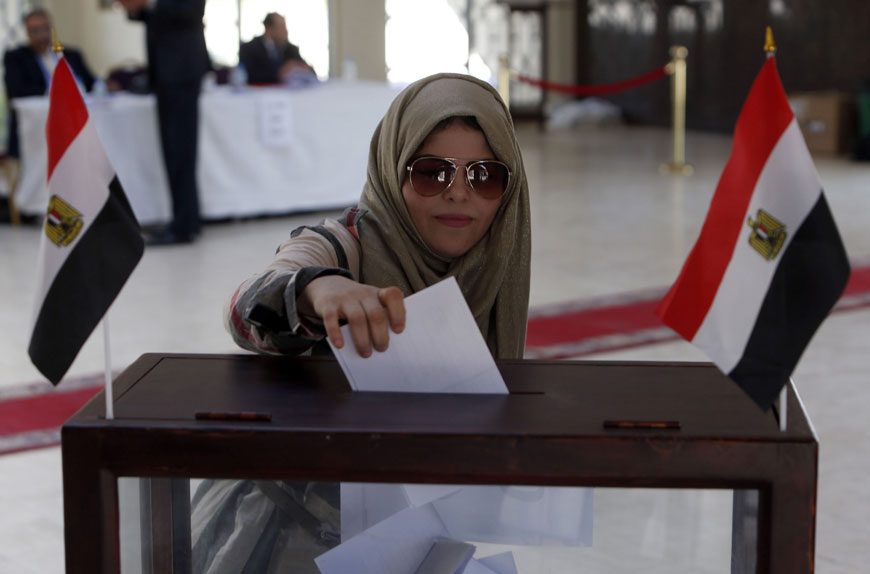 An Egyptian national, living in Oman, casts her ballot in the Egyptian parliamentary elections at the Egyptian embassy in Muscat on Saturday (AFP photo)
