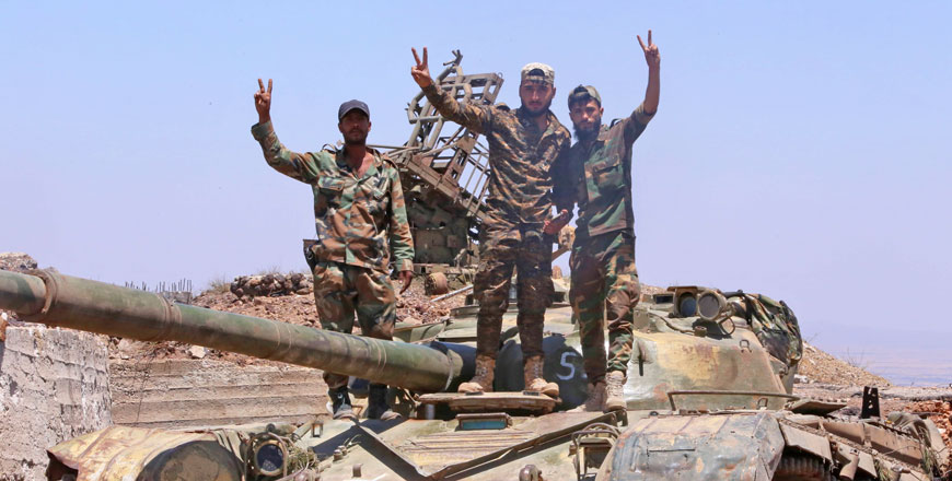 Syrian government forces’ soldiers pose for a photograph in the city of Quneitra after taking it back from the rebels on Thursday  (AFP photo)