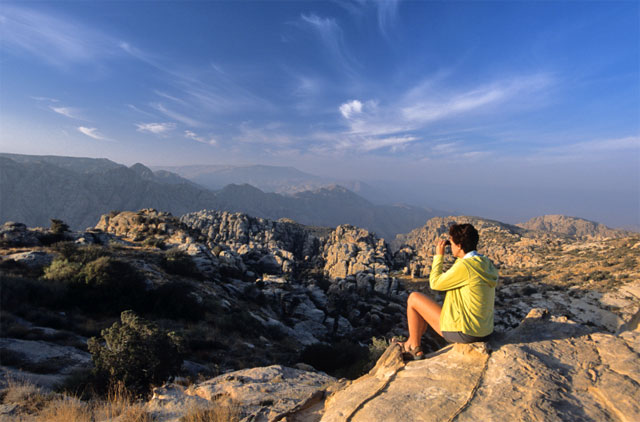 In this undated photo, a tourist takes a photo of Dana Nature Reserve, which potentially has vast deposits of copper that are being explored by a local firm (Photo courtesy of visitjordan.com)