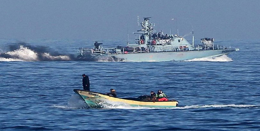 In this file photo taken in July last year,  Gazan fishermen are seen near an Israeli ship near the strip’s Mediterranean coast  (Photo courtesy of Quds Press)