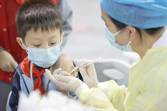 This photo taken on November 15, shows a child receiving a Covid-19 vaccine in Xiamen, in China’s eastern Fujian province (AFP photo)