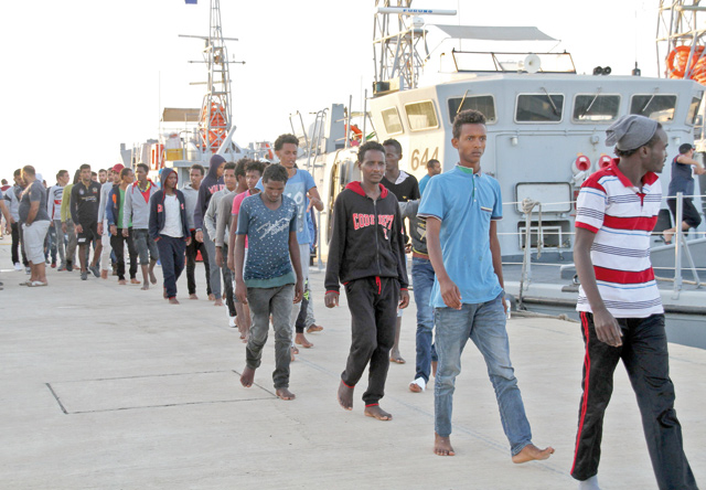 African migrants, who according to the Libyan navy were rescued by the country's coast guard, arrive at the naval base of the capital Tripoli on July 12 (AFP photo)