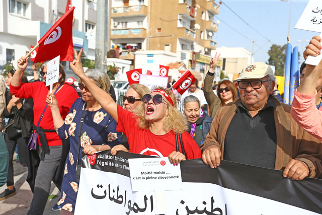 Hundreds of demonstrators hold placards and shout slogans during a march from Bab Sadun to Bardo square, demanding equal inheritance rights for women in Tunis, Tunisia, on Saturday (Anadolu Agency photo)