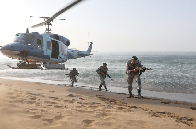This handout image provided by the Iranian army office on Sunday, shows Iranian soldiers participating in a military exercise on the shores of the southern Iranian Makran Sea, in the coastal region of Baluchistan (AFP photo/HO/Iranian Army Office)