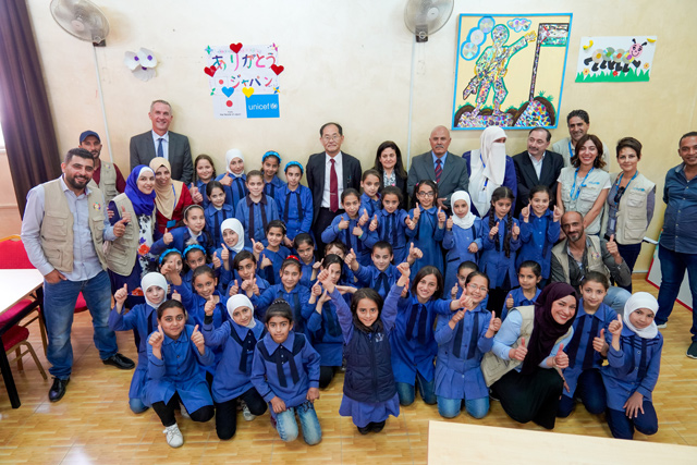 Japanese Ambassador to Jordan Hidenao Yanagi and UNICEF Representative Robert Jenkins pose for picture with students at the Princess Salma School in Amman on Wednesday (Photo courtesy of Japanese embassy in Amman)