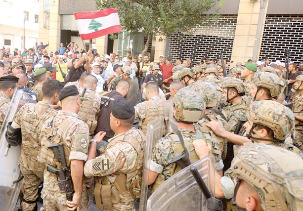 Lebanese soldiers clash with retired military personnel as they try to break into the parliament in Beirut on Monday, during a session to approve the 2022 budget (AFP photo)