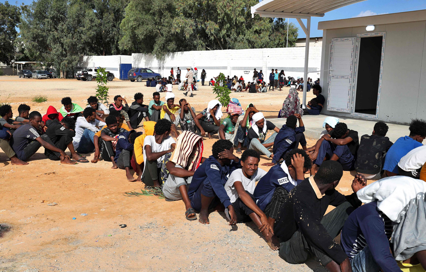 African migrants gather at a makeshift shelter in the capital Tripoli's suburb of Ain Zara, on Monday (AFP photo)