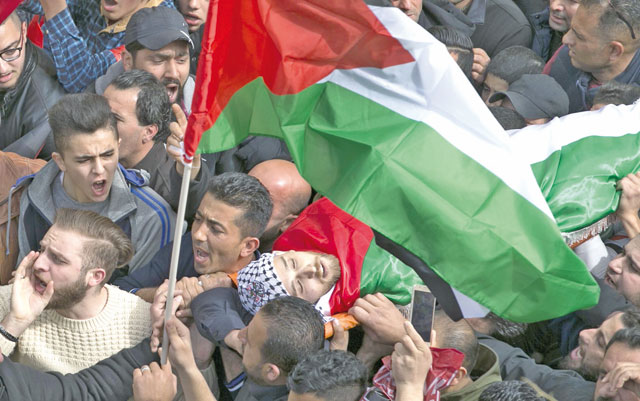 Mourners carry the body of Palestinian Khaled Tayeh, who was killed by the Israeli army during a manhunt for a militant suspected of murdering a rabbi, during his funeral in the West Bank city of Nablus on Wednesday (AFP photo)