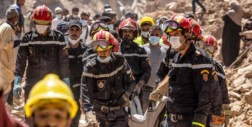 Rescue workers carry a body recovered from the rubble of an earthquake-damaged house in Imi N'Tala village near Amizmiz on Wednesday (AFp photo)